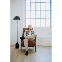 man relaxing in a custom brown recliner in a studio apartment