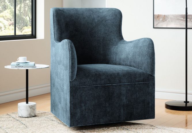 A sleek, modern dark blue velvet swivel chair in a calming living room