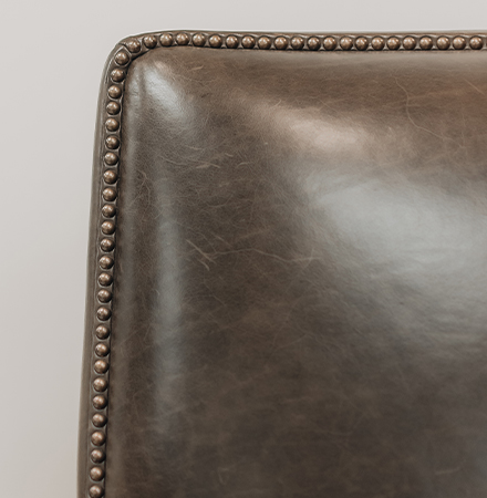 bronze nailhead trim on brown leather chair