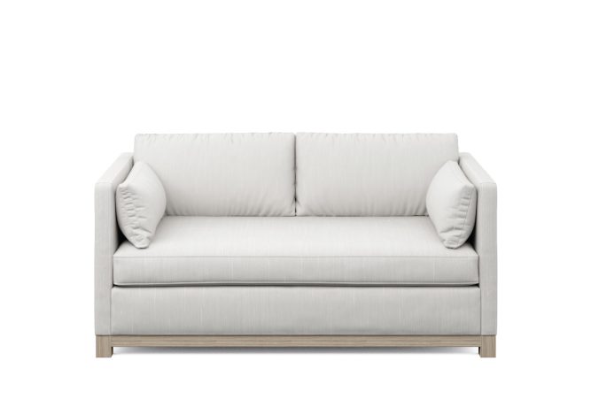 white modern loveseat with wood base and side pillows