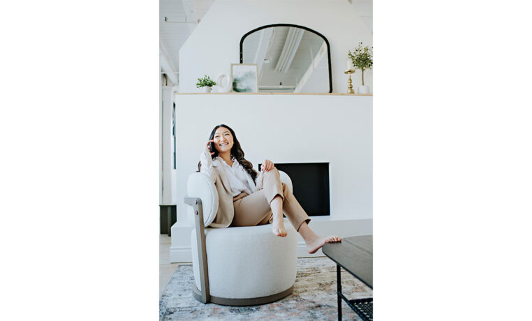 a custom white swivel chair with a woman taking a call in it