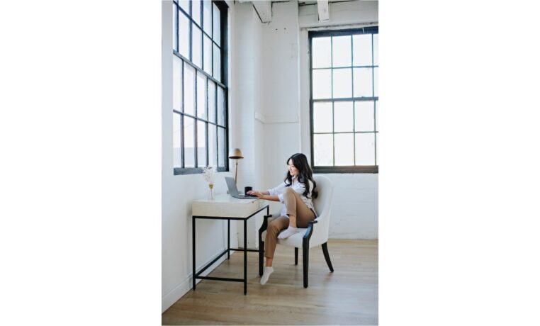 woman working from home in a loft with elegant dining chair