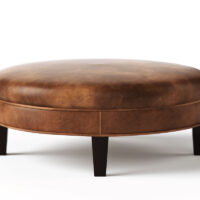 Round Carlisle ottoman from Vogel by Chervin in brown leather and espresso legs with a flat top