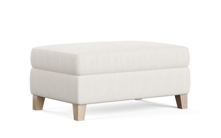 a transitional ottoman in a white fabric with oak legs